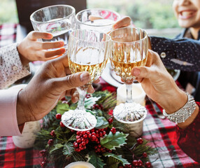 Family clinking with glasses at Christmas dinner table