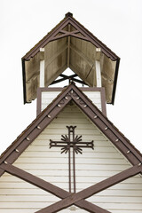 Fototapeta na wymiar Close up details of a steeple of a wooden white church in old town in BC. Top of the rural church