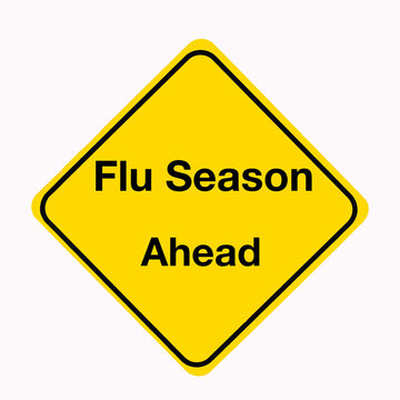 Bright yellow Road sign with the message, Flu Season Ahead, as a medical concept sign.