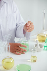 Scientist research with petri dish and a white background in laboratory , color liquid in a test tube and scientist for cosmetic advertising , photography science concept