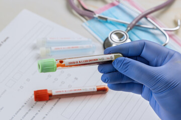 Tube containing a blood sample for COVID-19 that has tested positive of new version Omicron of...