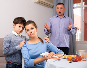 Ordinary family with teen son having quarrel at home. High quality photo