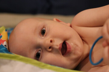 baby playing with toy in bed