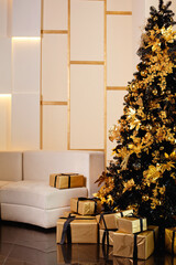 A Christmas tree with gold and black decorations and gifts under it.