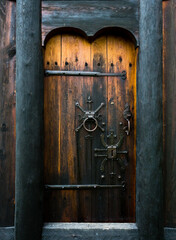 Black decorative wooden door of a turf house church in Iceland