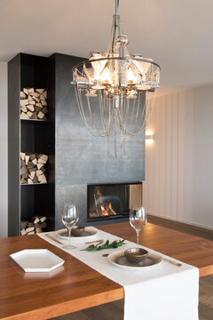 Dining room with industrial chandelier and metallic fireplace