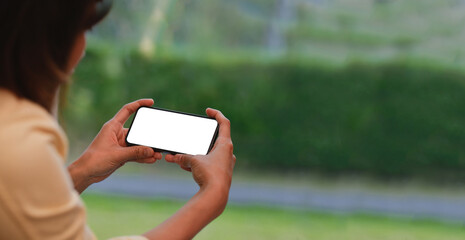 Young woman using smartphone at home. Student girl texting on mobile phone in her room....