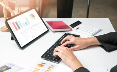 woman hands using portable tablet analyzing business graph chart.