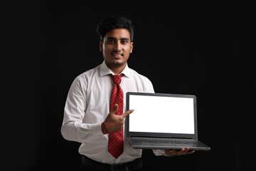 Young india student, banker or employee showing laptop screen.