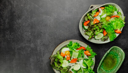 Vegetable salad. The best salad ingredients for weight loss with fresh lettuce, tomatoes and cucumber,olive oil in ceramic bowl. Top view. Copy space. No.06