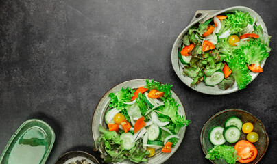 Vegetable salad. The best salad ingredients for weight loss with fresh lettuce, tomatoes and cucumber,olive oil in ceramic bowl. Top view. Copy space. No.05