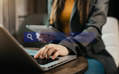Business women clicking internet search page on tablet and computer touch screen in office.