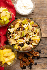 Apple salad with walnuts for Christmas on a wooden background