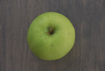 Granny Smith apples are small to medium fruits and range in shape from round, oval, to conical. The skin is smooth, firm, chewy, and thick, remaining bright green when ripe and covered in tiny.