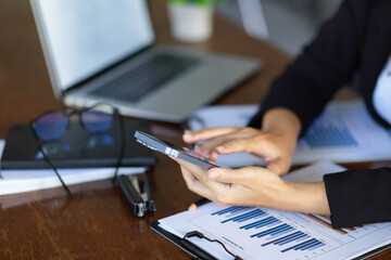 Cropped shot of a female financial accountant using smartphone