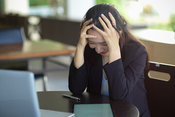 A thoughtful stressed female worker upset with her work result.