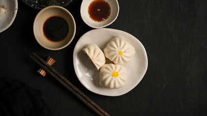 A plate of pork and mushroom buns with soy sauce