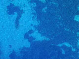 Background image of the turquoise sea. Deep sea and corals. Aerial drone shot of turquoise water. Aquamarine background
