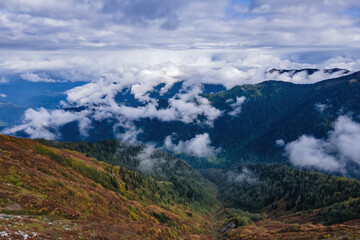 Aerial view above the clouds in mountain valley at morning