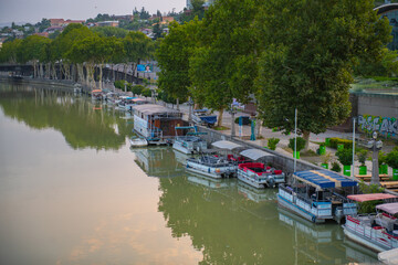 muddy river kura and pier with boats © Vyacheslav