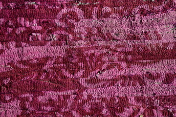 Textile background, a multicolored long-used handmade carpet cloth made of old clothes cut into strips and intertwined with thick, strong threads