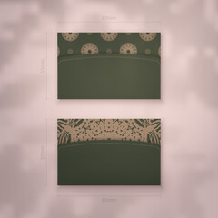 Business card in green color with mandala pattern in brown for your business.