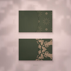 Business card in green with a luxurious brown pattern for your contacts.