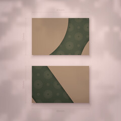 Business card in green with abstract brown ornament for your personality.