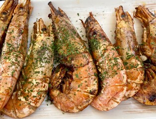 Delicious fried shrims, Grilled giant river prawn on a white plate, Barbecue seafood party, Traditional food recipe.