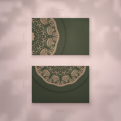 Business card in green with greek brown pattern for your business.