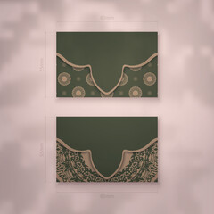 Business card in green with greek brown pattern for your business.