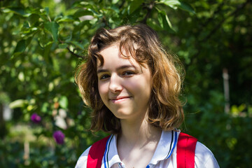 Pretty young teenager girl at green park. Outdoor portrait on sunshine