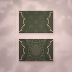 Business card in green with vintage brown ornament for your business.