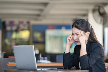 businesswoman gets stressed while having a problem at work in the office.