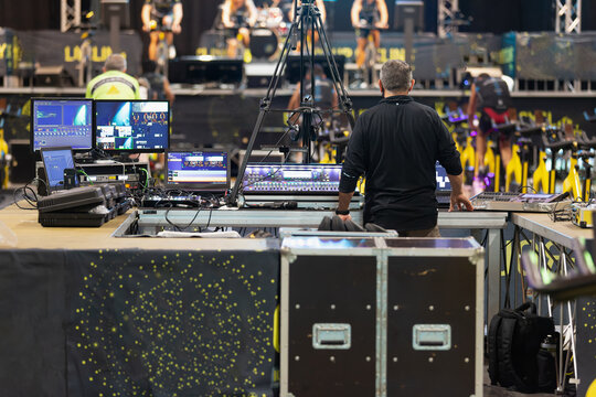 Lighting and Sound Technician and Broadcast Operator at Work in the BackStage during a Public Event