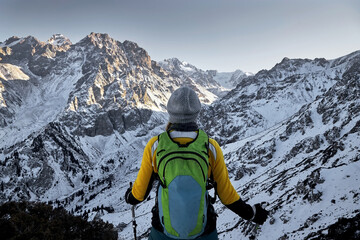 Hiker is standing against mountain landscape near Almaty city, Kazakhstan