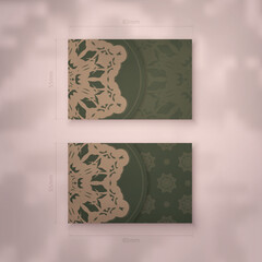 Business card template in green color with greek brown ornaments for your brand.