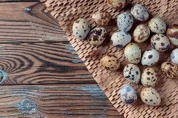 Top view of Quail eggs on wooden background. With copy space.