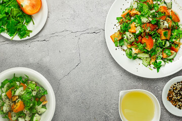 Mediterranean salad with tomatoes, cucumber, coriander, onions, olive oil and lemon in a white ceramic plate. Healthy vegetarian food, oriental and Mediterranean cuisine. Top view. Copy space. No.05