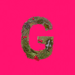 Festive, winter, Christmas season natural pine, holly branches, red berries, unique collection of letters, numbers and symbols. Letter G