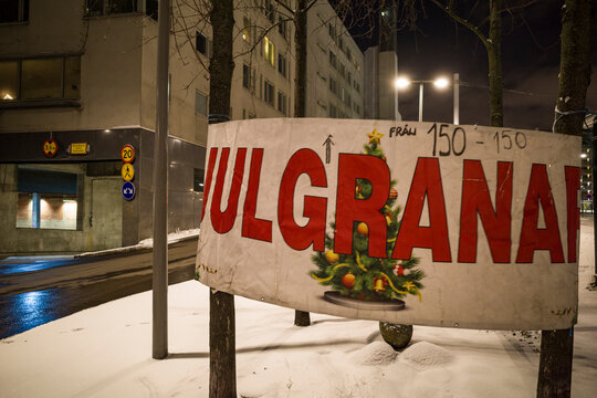Stockholm, Sweden A sign in Swedish at Liljeholmen pointing to the sale of Christmas trees, Julgranar in Swedish.