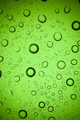 Texture water drops on green glass.