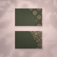 Business card template in green with abstract brown ornament for your brand.