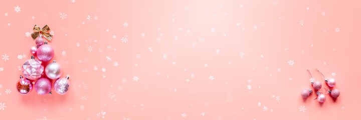 Fototapeta na wymiar Innovative Christmas tree made of Christmas ornaments on pink background, banner size