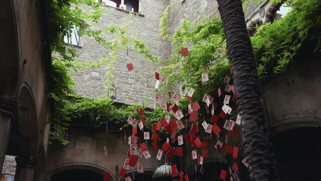 Barcelona - La Casa de l'Ardiaca with hanging card installation above a fountain alt angle