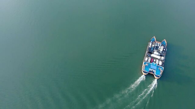 Navrom Ferry Boat Sailing Across Danube River Carrying Vehicles Arriving At The Port In Galati City, Romania. - Aerial, Drone Shot