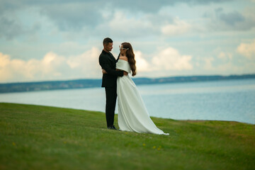 beautiful adult wedding couple on a green lawn