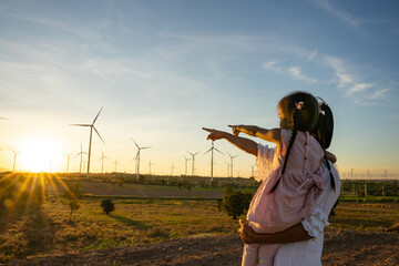 Wind turbines are alternative electricity sources, the concept of sustainable resources, People in...