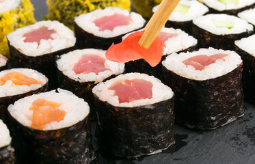 chinese sticks put ginger on rolls, close-up