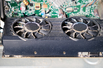 Fototapeta na wymiar Dirty video card, dust inside the system unit of the computer.